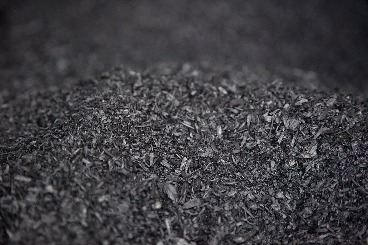 Close-up of biochar: fragments of black plant-based charcoal.